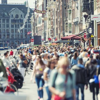 Amsterdam the Netherlands Horizontal color image of a crowded Damrak in Amsterdam. No social distancing applied.